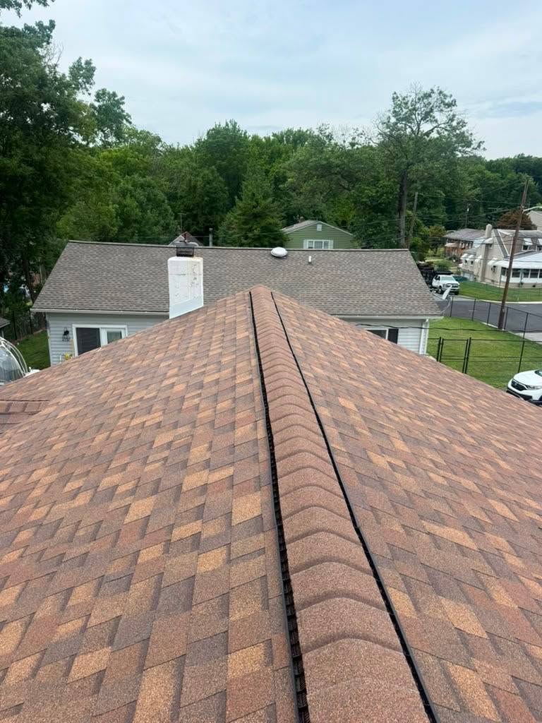Finished shingle roof ridge on a neighborhood home