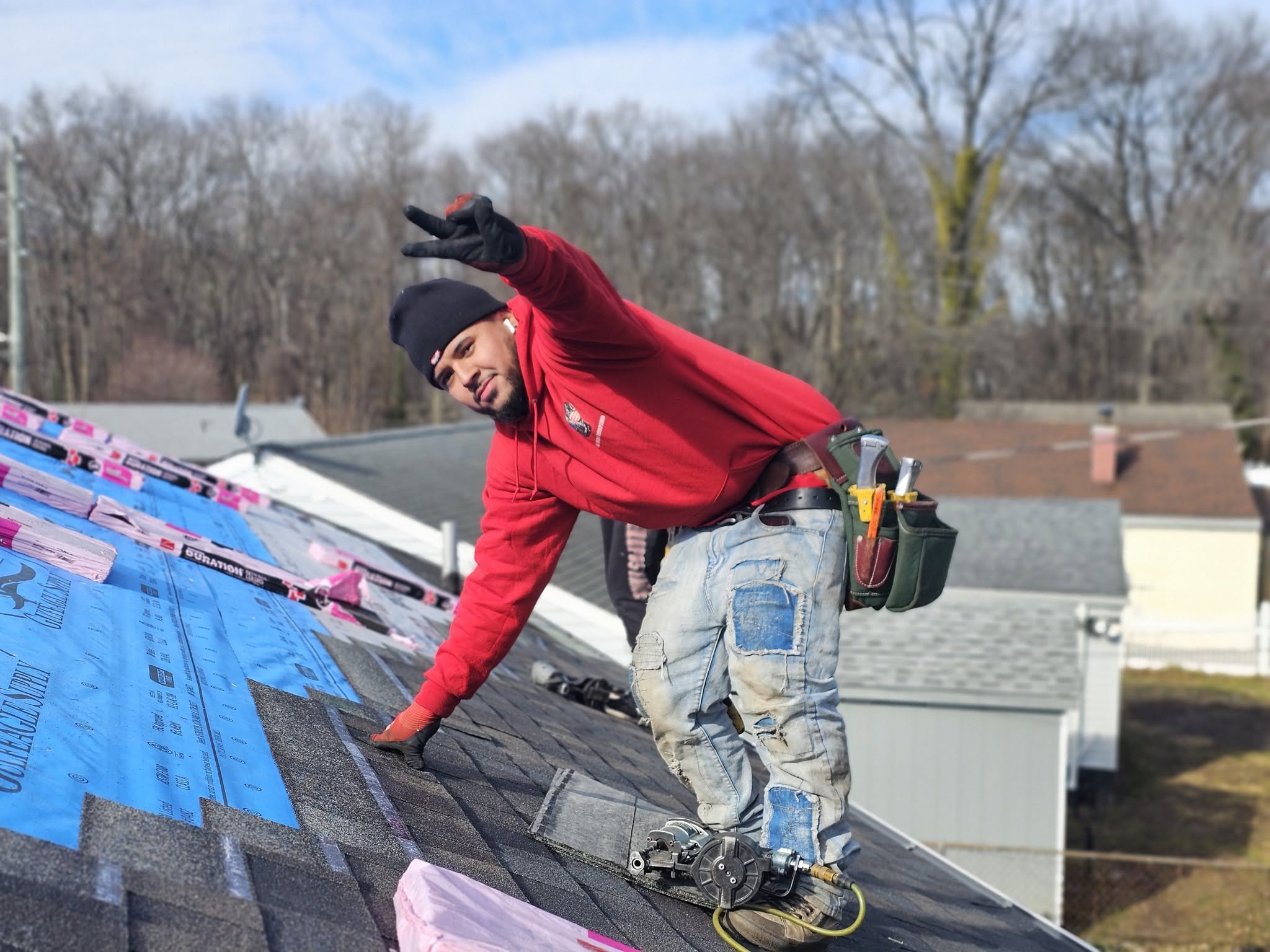 BluDog crew member installing shingles on a roof
